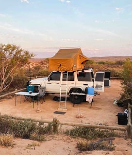 Landcruiser and camping setup at sunset in Western Australia.