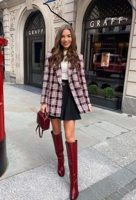 a woman in a plaidered jacket and knee high boots