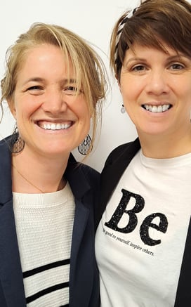 deux femmes debout l'une à côté de l'autre dans une pièce