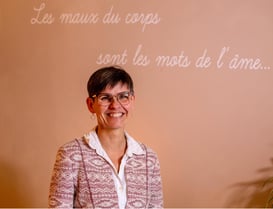 a woman in a pink shirt and glasses
