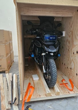 a motorcycle parked in a storage room with a motorcycle