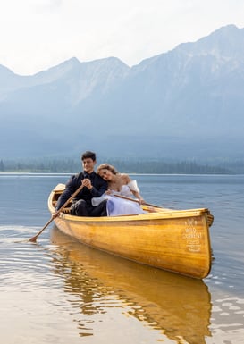 Bride and groom in a canoe on a lake in Jasper