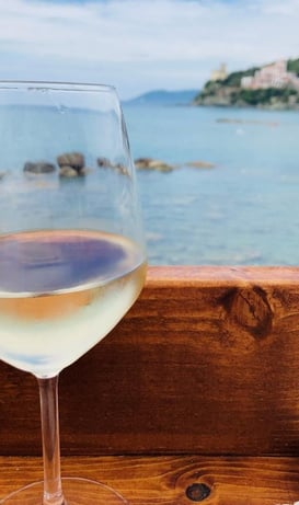 a glass of wine on a wooden table