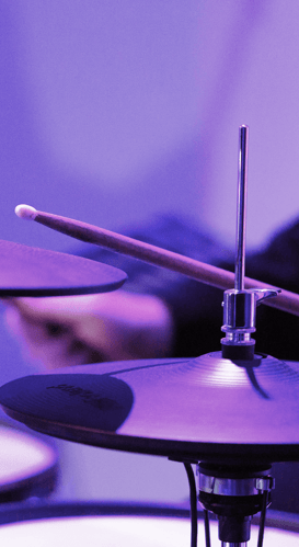 Purple lighting with up close drums
