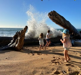 Kids playing in the ocean in Kauai Hawaii