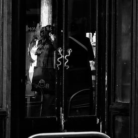 Two women through a glass door of a cafe in West Port, Edinburgh