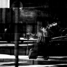 A very distorted view of a woman with a trolley suitcase in Exchange Plaza, Edinburgh