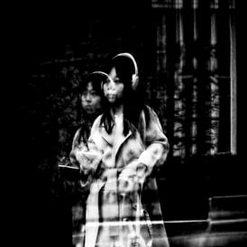A woman doubly reflected in a window on Simpson Loan, Edinburgh