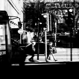 People crossing the road, reflected in glass at Haymarket, Edinburgh