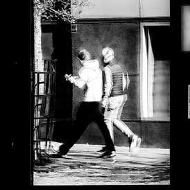 Two men walking, reflected in a window at High Riggs, Edinburgh