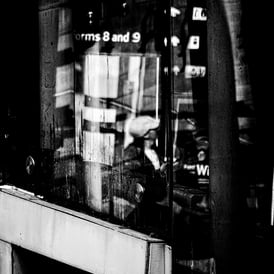 Distorted figures, taken through glass at  Market Street entrance, Waverley Station, Edinburgh
