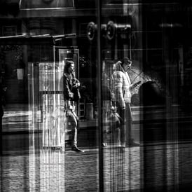 Two people, slightly distorted by glass. The Usher Hall, Edinburgh