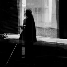 A woman reflected in glass, Fountainbridge, Edinburgh