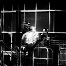 Three people chatting outside the Lloyds Building reflected in window. Fountainbridge, Edinburgh