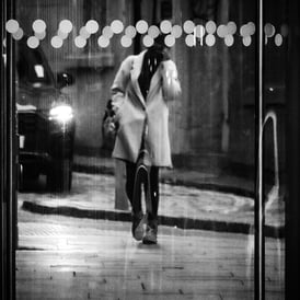 A woman walks towards a glass door at West Port, Edinburgh