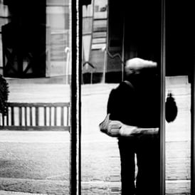 A woman reflected in glass in Ladyfield, by the EICC, Edinburgh