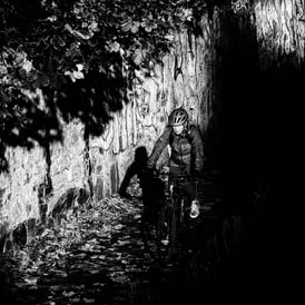 A woman on her bike, cycle through the shadows on the canal path near Yeaman Place, Edinburgh