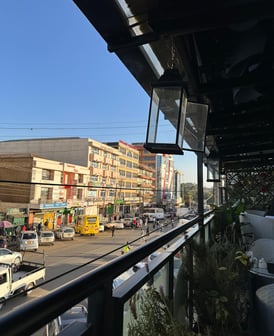 a view of a city street with cars parked on the side of the street