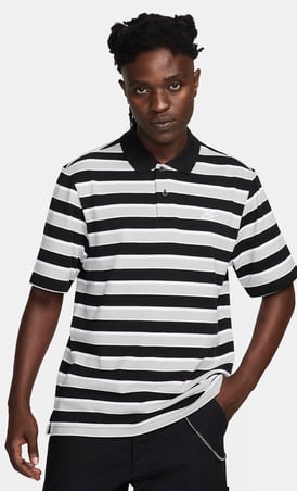 a man in a striped shirt and black pants vintage