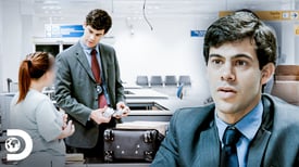 a man in a suit and tie is holding a suitcase