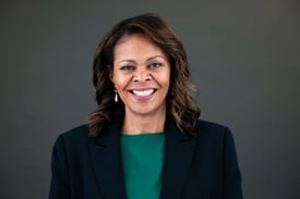 a woman in a green top and a black jacket