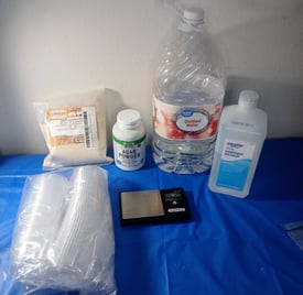 Supplies for pouring agar into ketchup cups — pressure cooker, agar powder, foil, and condiment cups