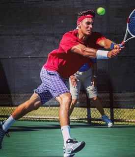 Photo of The Health Unit Founder Dan Manlow playing college tennis