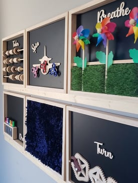 bulletin board with sensory items on wall
