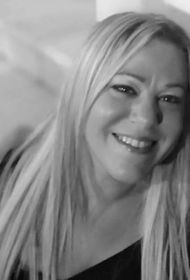 a woman with blonde hair and a black shirt
