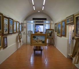 a room with a lot of paintings and paintings
