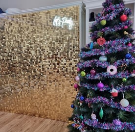 Gold shimmer wall for a xmas party in Cannon Hill with the Let's Party neon sign right next to their Xmas tree.