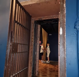 Photo inside the Vault function room looking out into the waiting room with children playing with hanging chains.