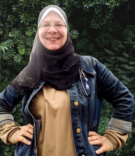 a woman wearing a hijab and smiling