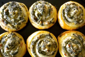 a bunch of rolls of spinach pin wheels