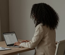 female business coach sat in front of computer