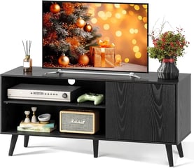 a tv unit with a tv and a shelf