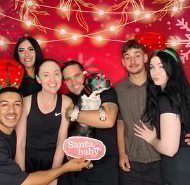 Carly from SweetAz Co. with her two daughters and dog Phoenix in the Christmas-themed open air photo booth in Redlands.