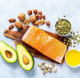 a salmon steak with avocado, nuts, nuts, and nuts