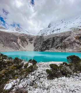 Breathtaking view of Laguna 69, with its vibrant turquoise waters and majestic glaciers in the Huaraz region of Peru.