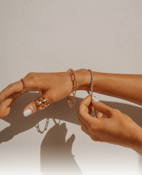 a woman's hands with rings and bracelets