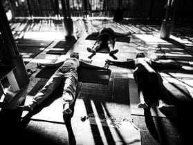 Yoga practitioner lie in a relaxtion pose after practise.