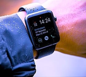 a person wearing a black watch and a black watch
