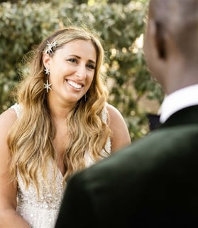 Bride smiling at groom during outdoor Provence elopement ceremony, captured by fine art wedding phot