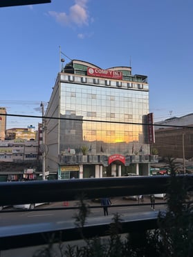 a building with a large glass building in the background