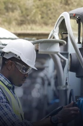 a man in a white helmet and safety glasses