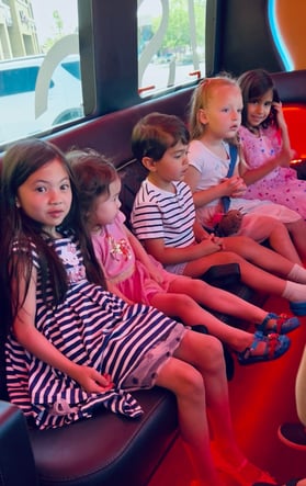 Kids on party bus on their way to Claw Store
