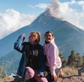 Eva and Manon in front of the eruption of Fuego Volcano, Guatemala.