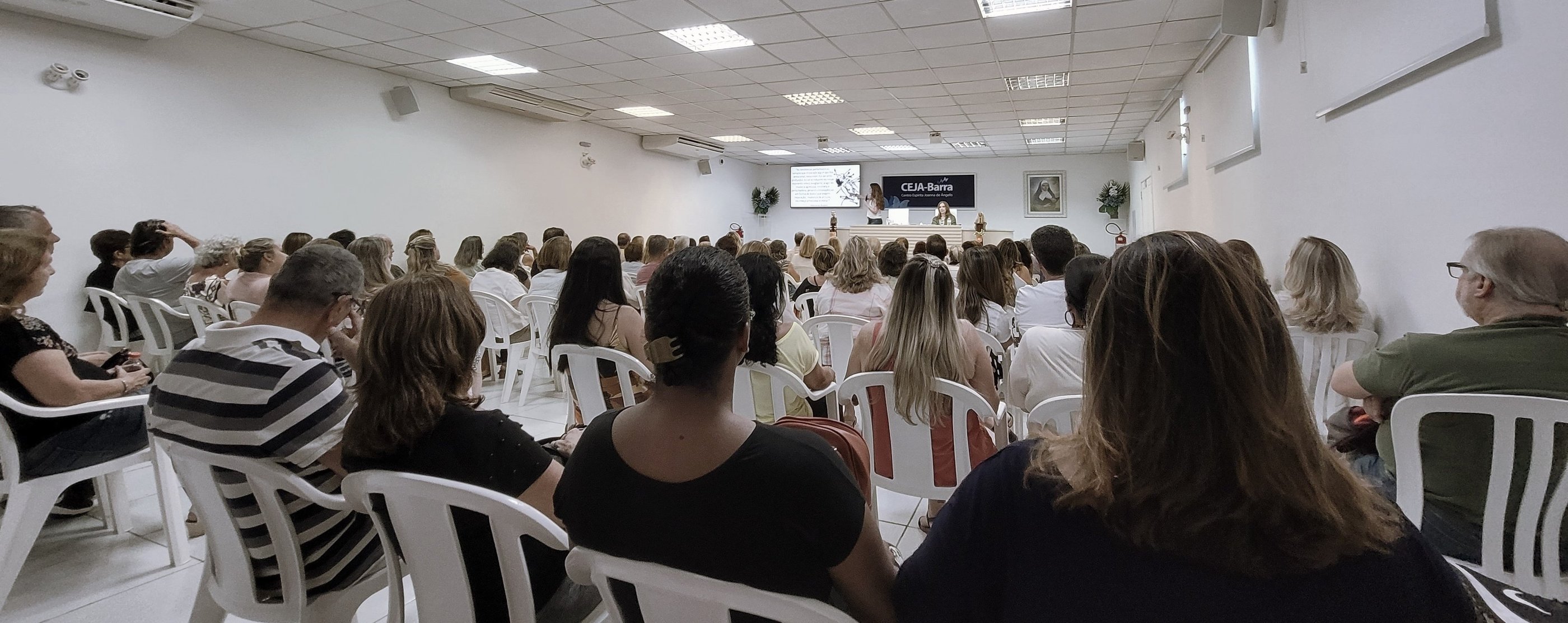 a group of people sitting in chairs in a room