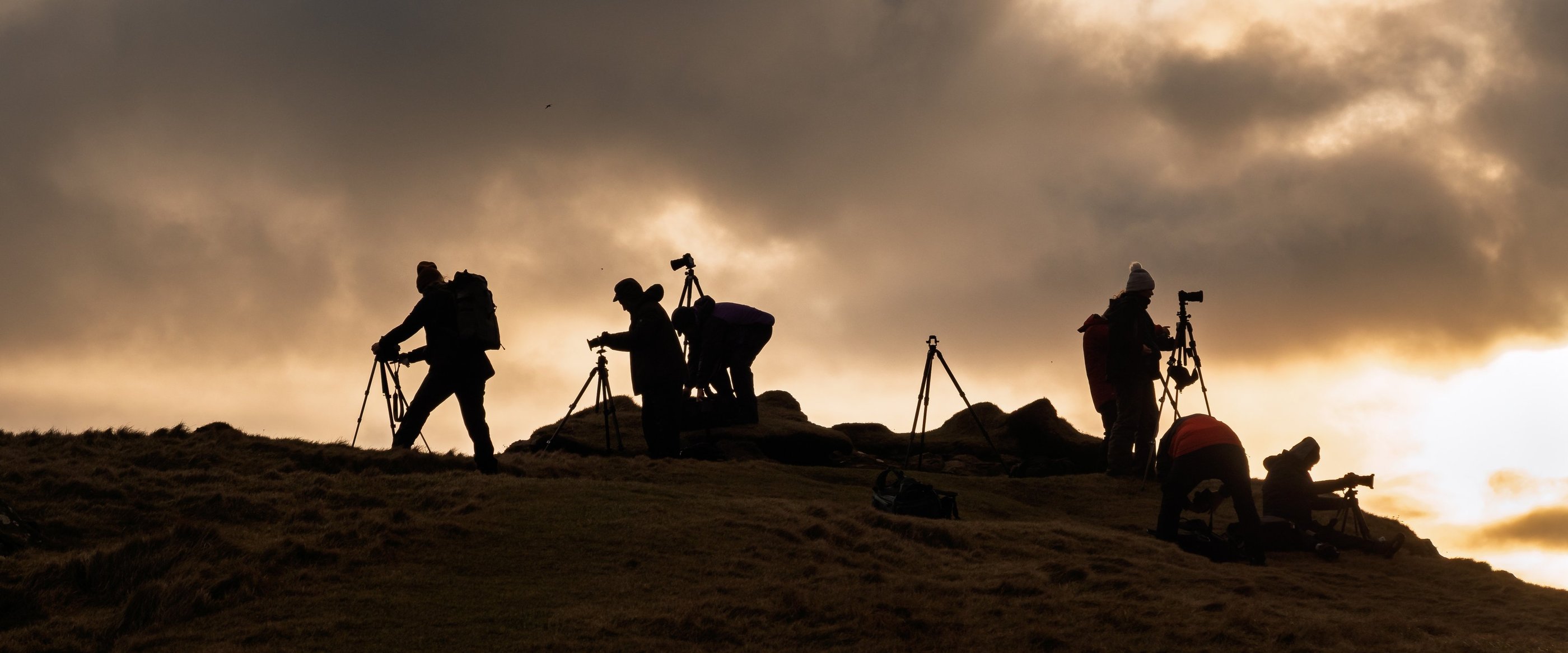 Photographers shooting at sunrise during a Faroe Islands photography workshop tour