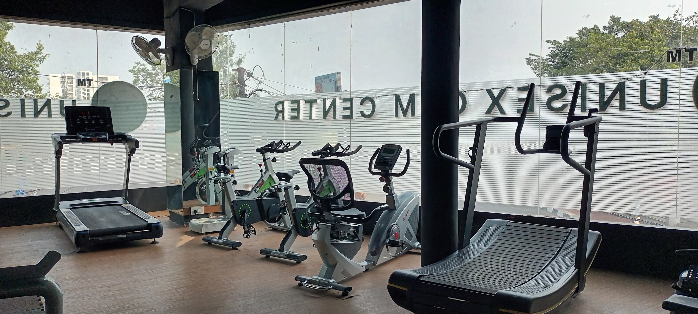a gym room with a variety of exercise equipment